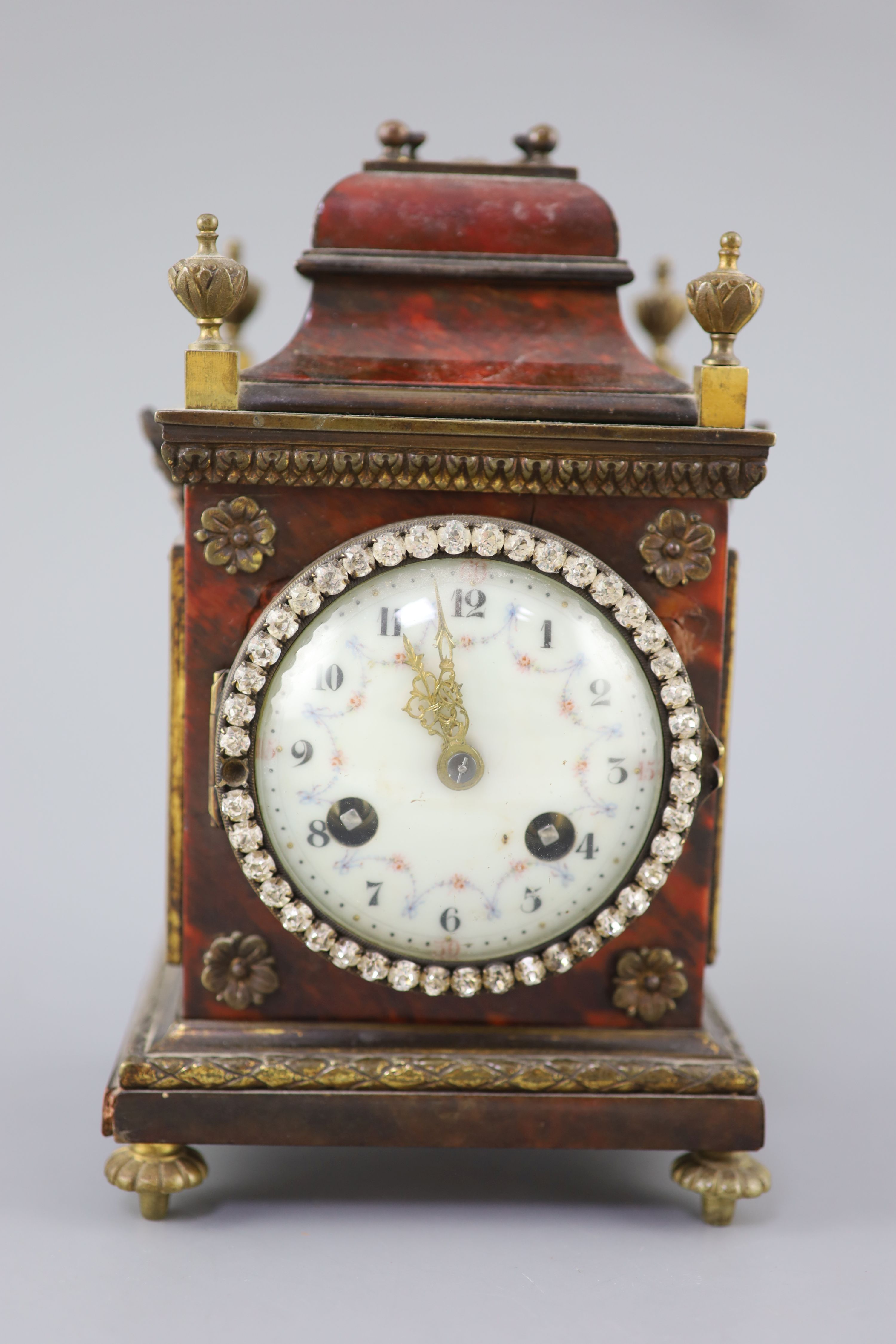 An early 20th century red tortoiseshell veneered mantel timepiece, height 8in.